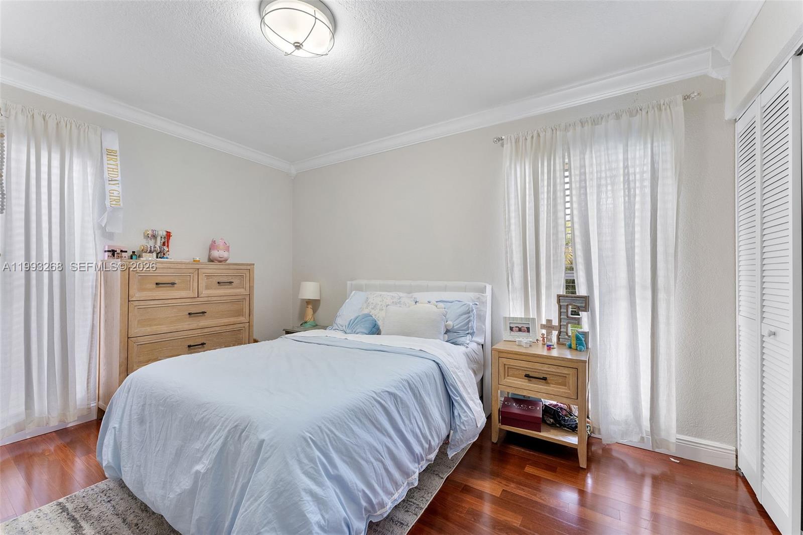 11798 Southwest 32nd Street Miami, FL 33165 - Photo 23 of 31 a bedroom with a bed and a chair