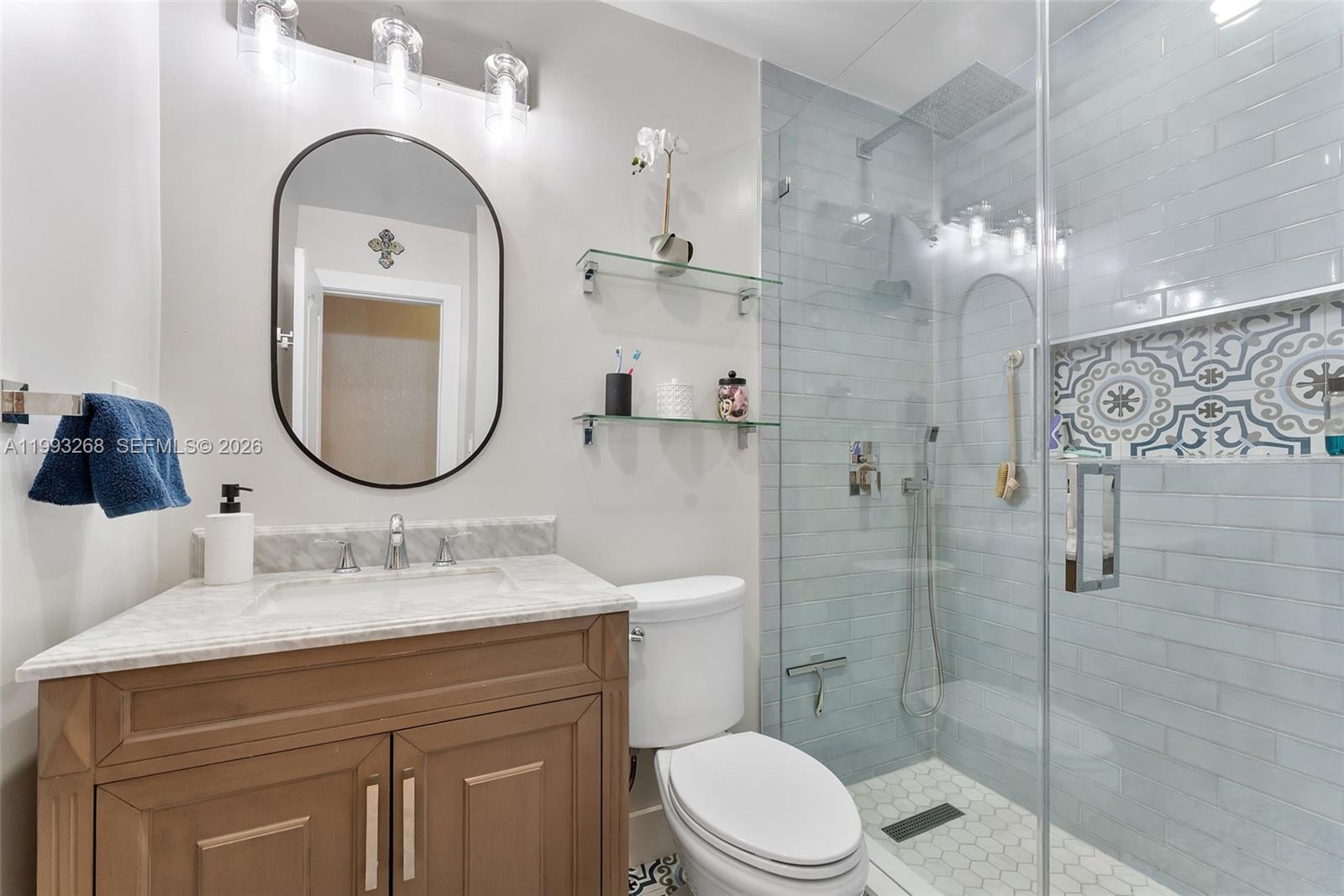 11798 Southwest 32nd Street Miami, FL 33165 - Photo 24 of 31 a bathroom with a sink a toilet and a mirror