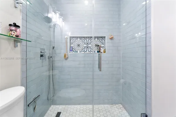 a bathroom with a shower toilet and sink