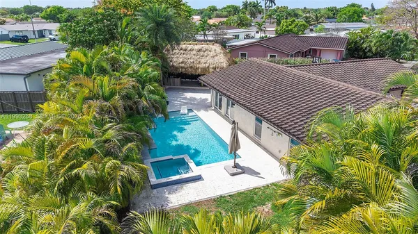 a view of a patio with table and chairs and potted plants