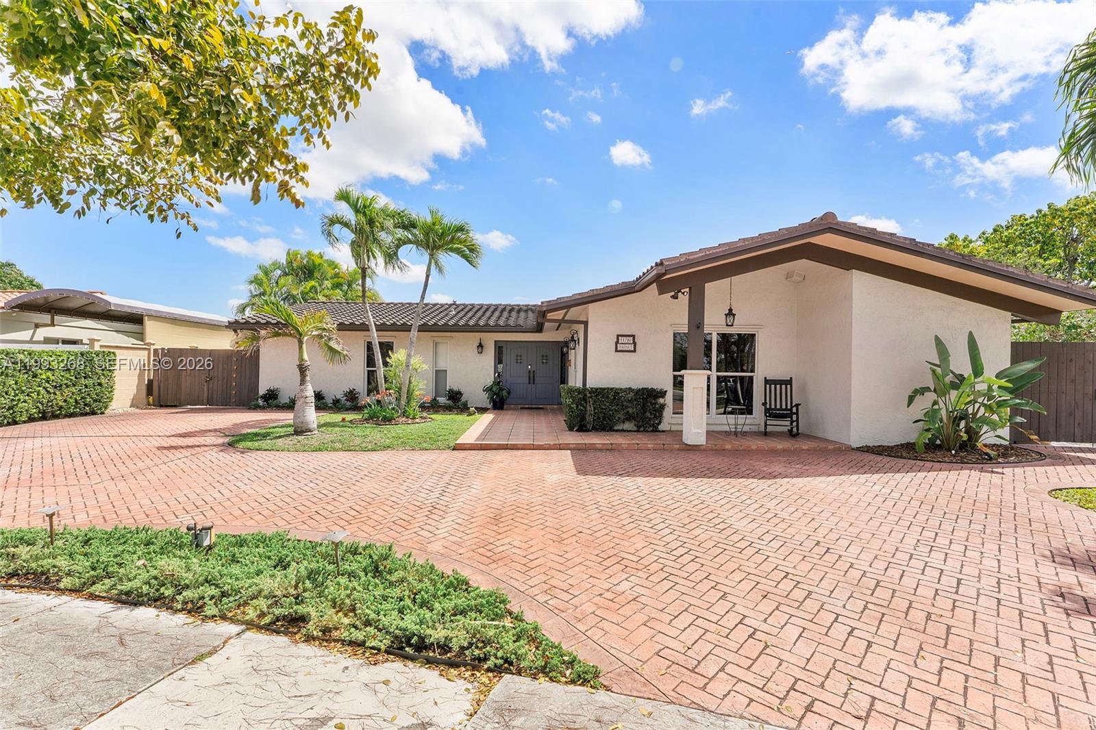 11798 Southwest 32nd Street Miami, FL 33165 - Photo 7 of 31 a front view of a house with a yard and a garage