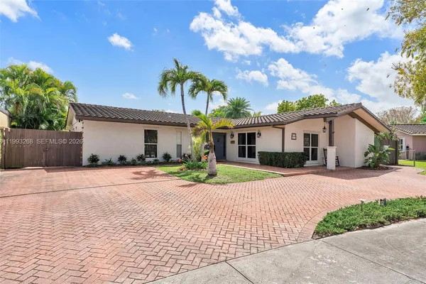 a front view of a house with a yard and a garage