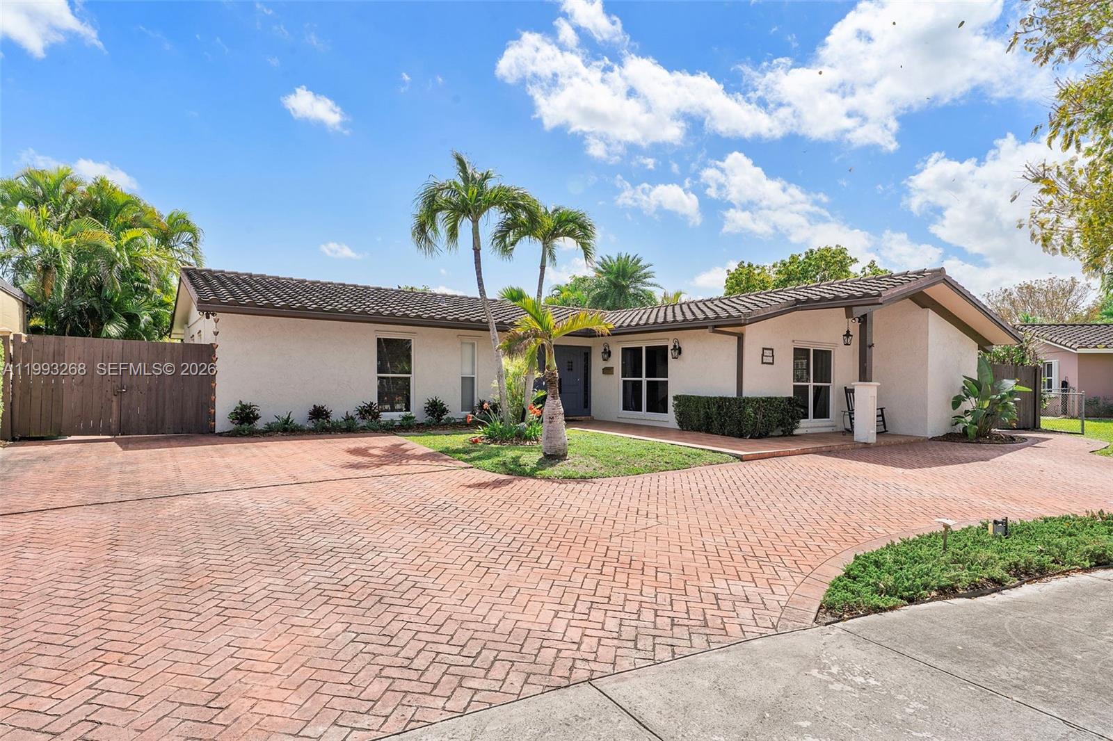 11798 Southwest 32nd Street Miami, FL 33165 - Photo 8 of 31 a front view of a house with a yard and a garage