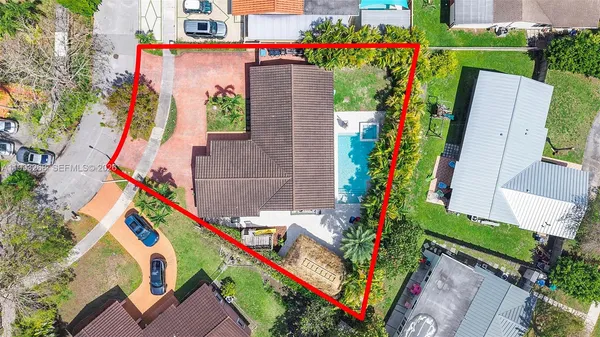 an aerial view of a house with a yard and outdoor seating