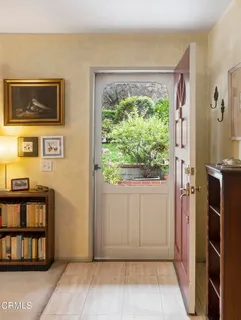 a view of an entryway with wooden floor