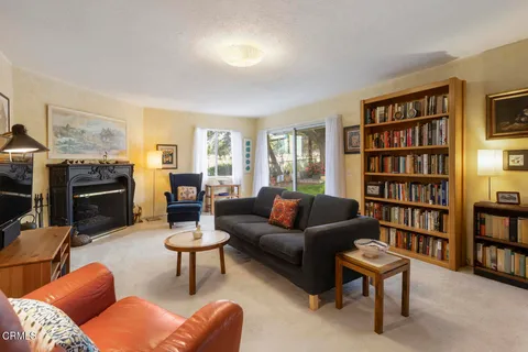 a living room with furniture and a book shelf