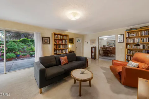 a living room with furniture and a book shelf