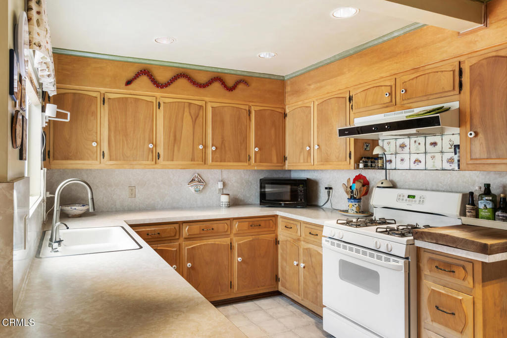 3624 Leilani Way Altadena, CA 91001 - Photo 6 of 18 a kitchen with stainless steel appliances granite countertop a sink and a stove next to a window