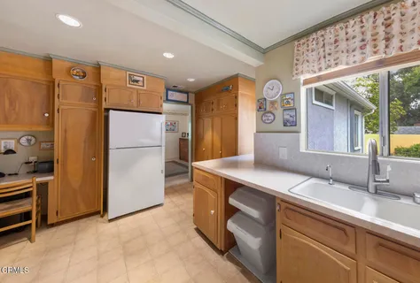 a kitchen with refrigerator cabinets and a sink