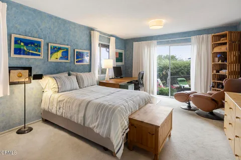 a bedroom with a bed and glass window