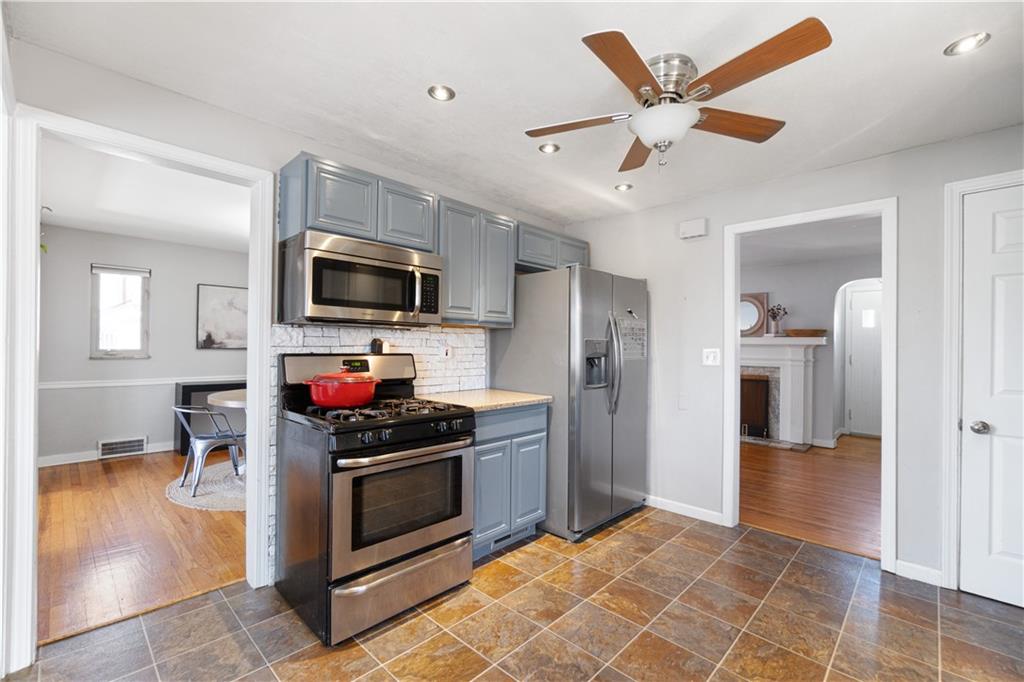 356 Spring Valley Road Pittsburgh, PA 15243 - Photo 15 of 36 a kitchen with a stove a refrigerator and a sink