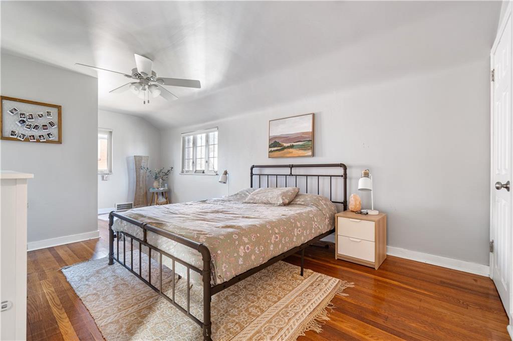 356 Spring Valley Road Pittsburgh, PA 15243 - Photo 22 of 36 a bedroom with a bed and wooden floor