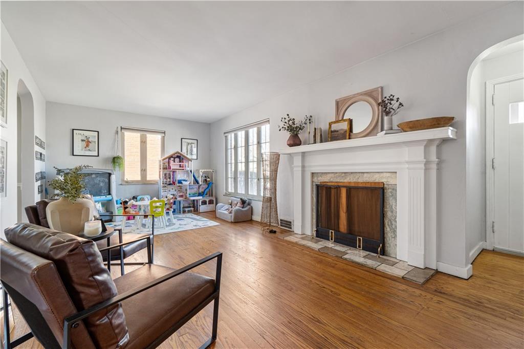 356 Spring Valley Road Pittsburgh, PA 15243 - Photo 5 of 36 a living room with furniture and a fireplace