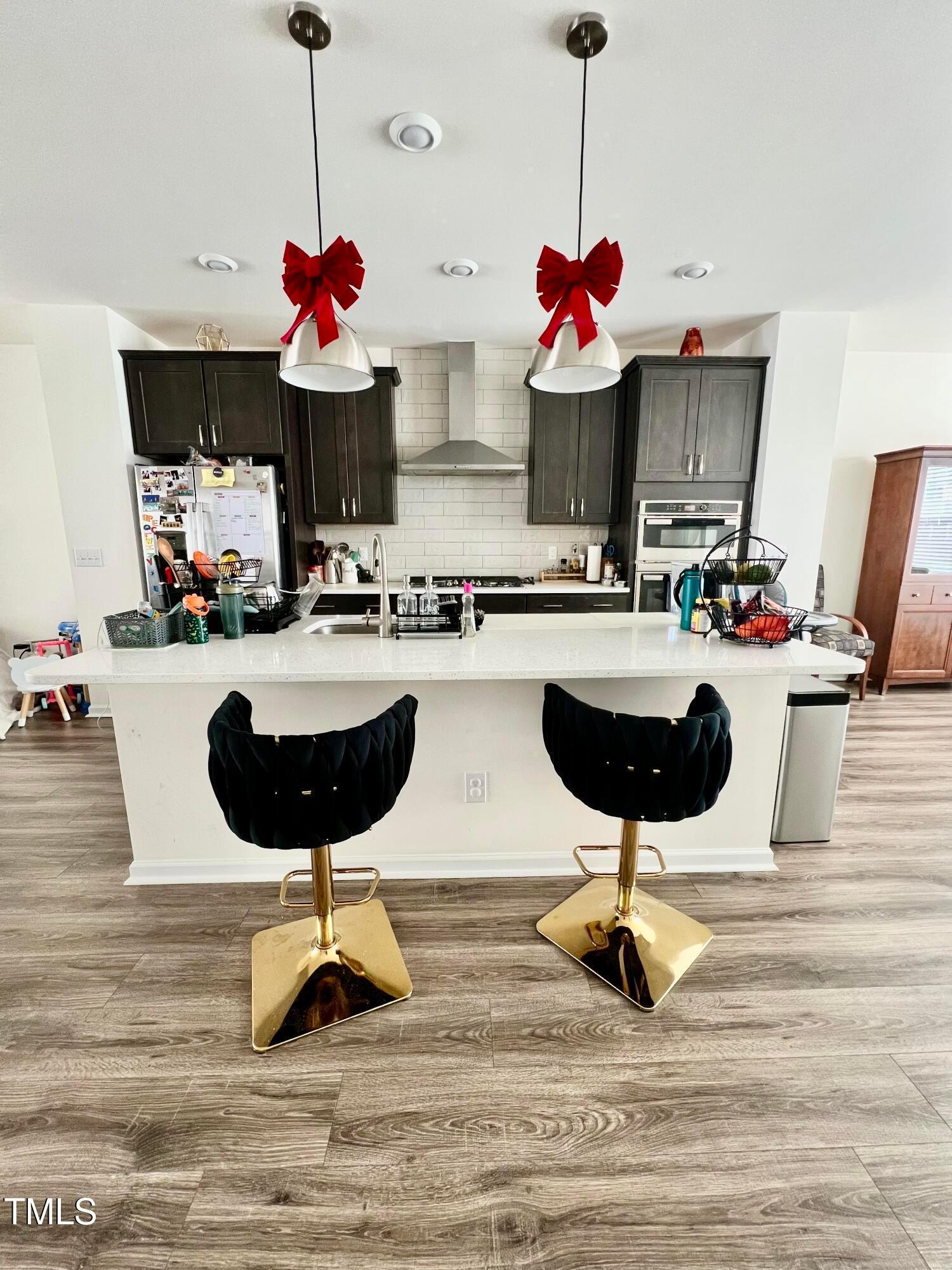6932 Leesville Road Raleigh, NC 27613 - Photo 33 of 51 a kitchen with a refrigerator and a stove