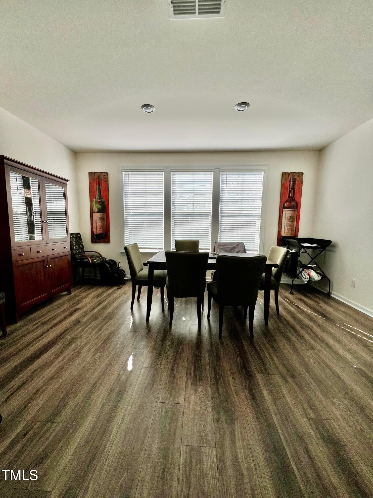 6932 Leesville Road Raleigh, NC 27613 - Photo 35 of 51 a view of a dining room with furniture window and wooden floor