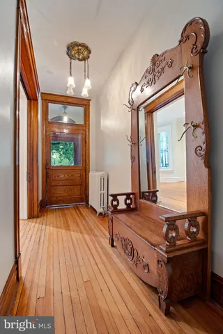 a view of a livingroom with wooden floor and a fireplace