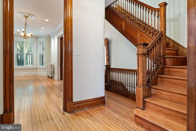 an empty room with wooden floor and a fireplace