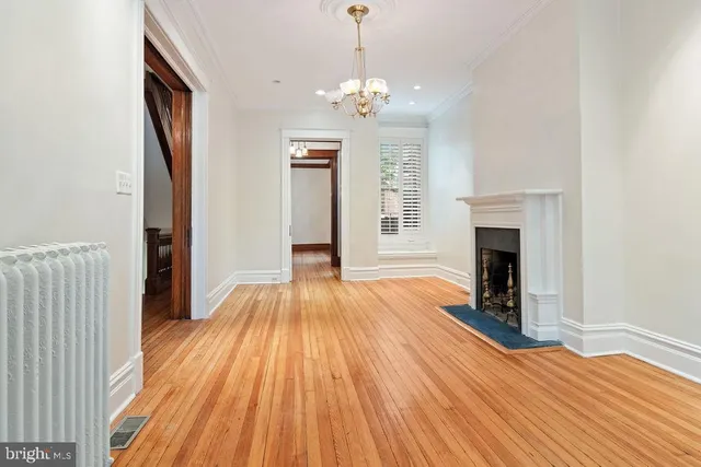 a view of a room with wooden floor and chandelier