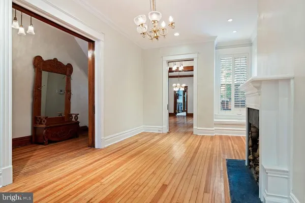 a view of a room with wooden floor and windows