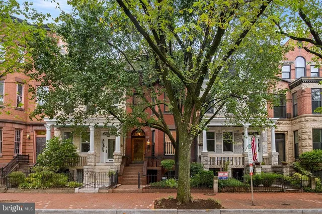 a view of a balcony with floor to ceiling windows and entryway
