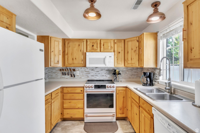 814 North 175 East Springville, UT 84663 - Photo 7 of 18 Kitchen featuring white appliances, light countertops, and light brown cabinets
