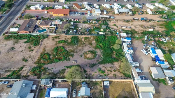 an aerial view of residential houses with outdoor space and parking