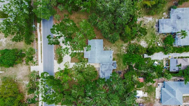 an aerial view of a house with a yard and garden