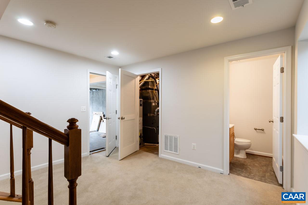 325 Rolkin Road Charlottesville, VA 22911 - Photo 30 of 32 a view of a hallway with wooden floor and stairs