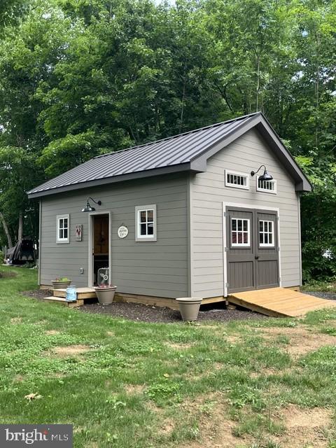 460 Wells Road Doylestown, PA 18901 - Photo 43 of 65 Charming shed nestled in lush greenery.
