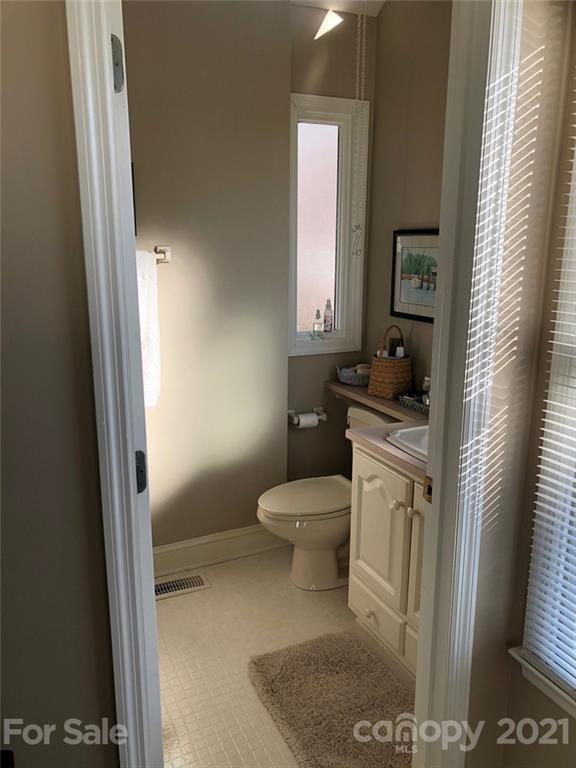 22382 Oakwood Road Albemarle, NC 28001 - Photo 14 of 21 a bathroom with a toilet a sink and a window