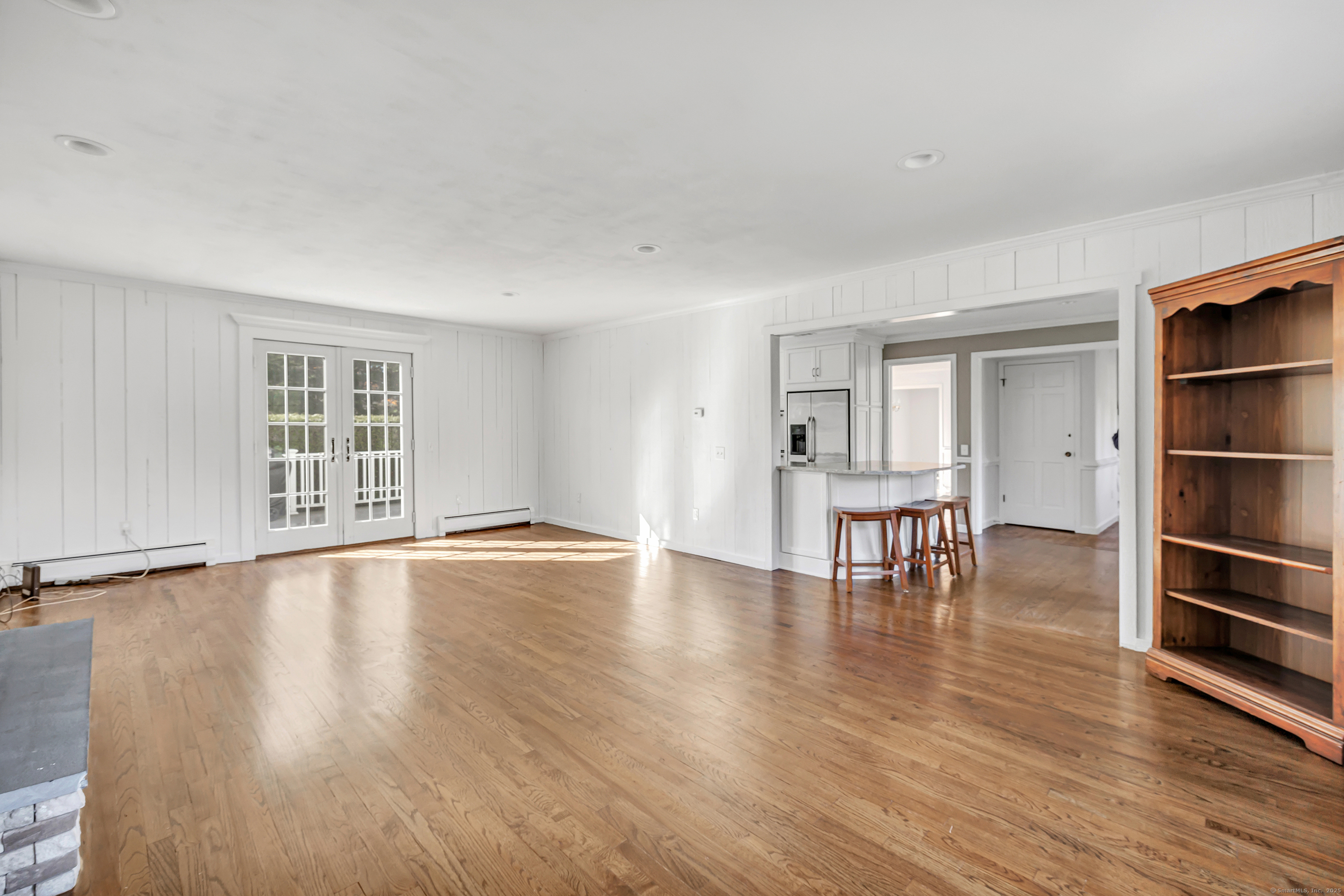 41 Butternut Lane Fairfield, CT 06890 - Photo 14 of 33 a view of an empty room with window and wooden floor