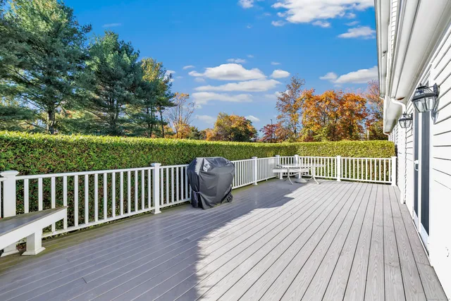 a view of balcony with wooden floor and fence