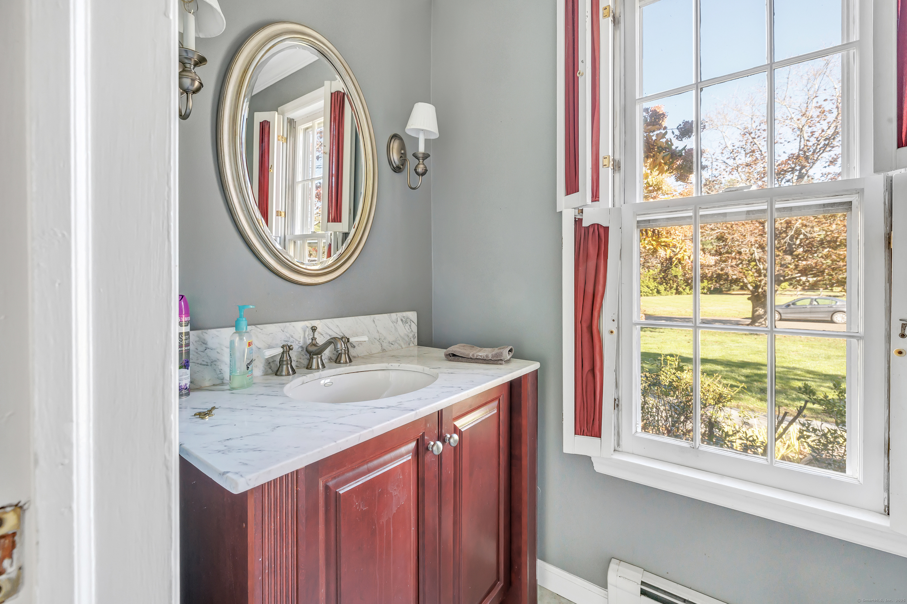 41 Butternut Lane Fairfield, CT 06890 - Photo 18 of 33 a bathroom with a granite countertop sink and a mirror