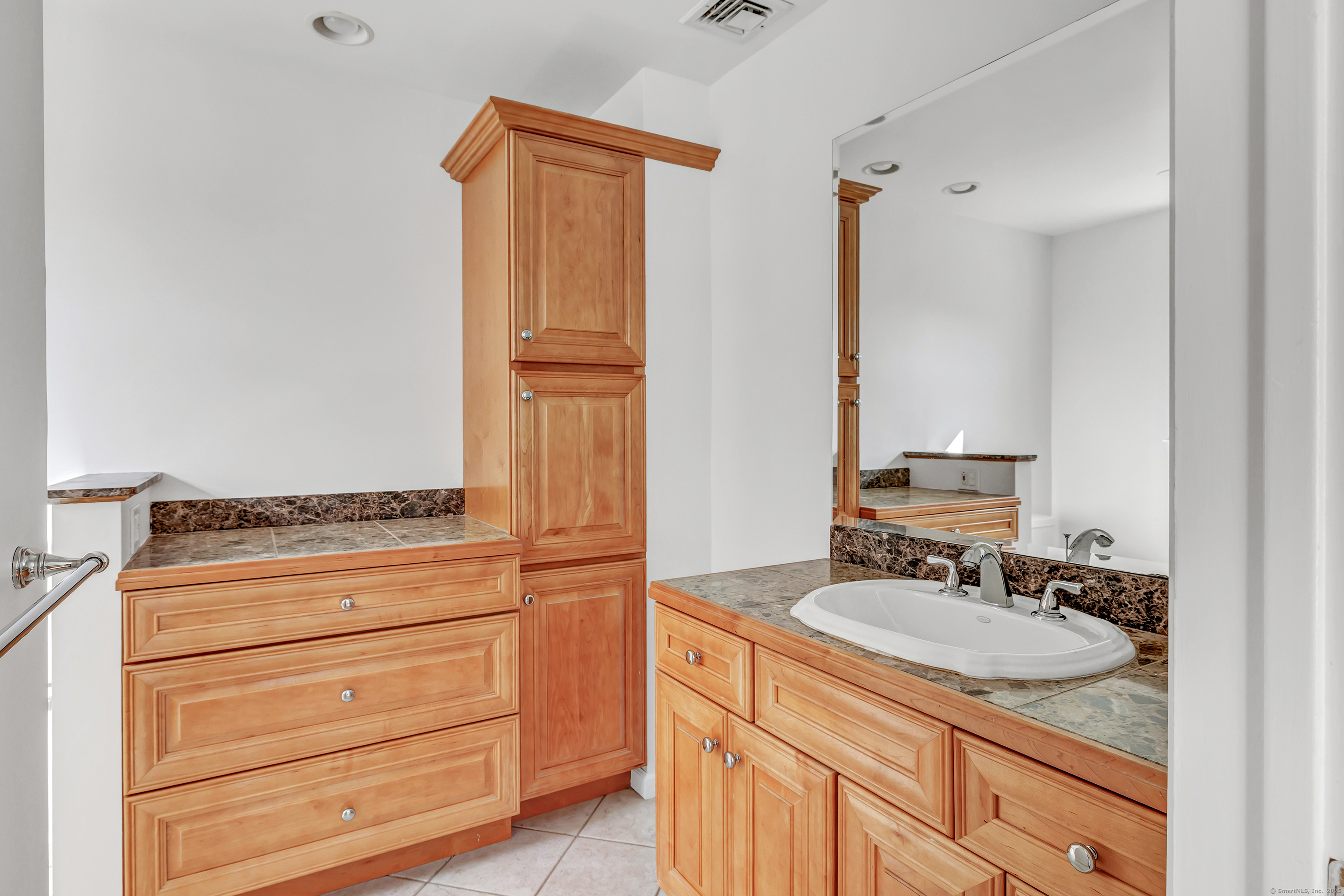 41 Butternut Lane Fairfield, CT 06890 - Photo 21 of 33 a bathroom with a granite countertop sink and a mirror