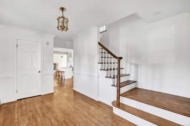 a view of entryway and hall with wooden floor