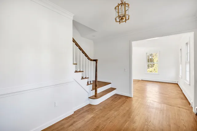 a view of an entryway with wooden floor