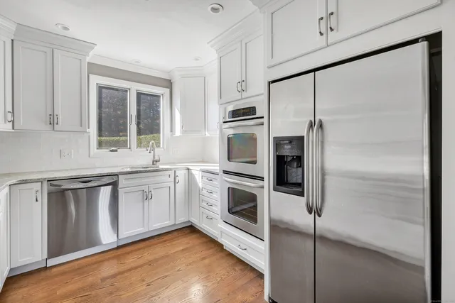 a kitchen with stainless steel appliances a refrigerator sink and cabinets