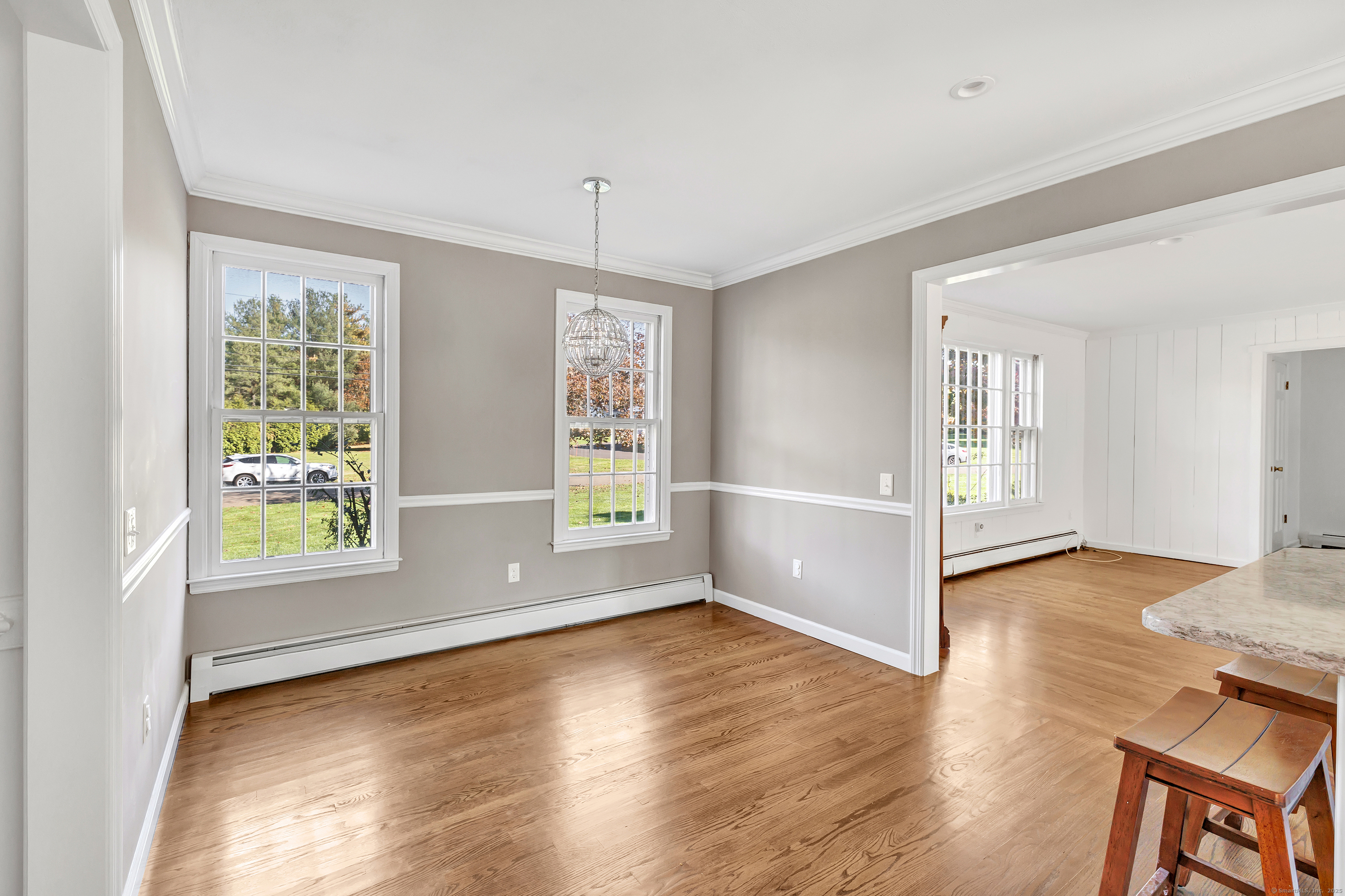 41 Butternut Lane Fairfield, CT 06890 - Photo 7 of 33 an empty room with wooden floor and windows
