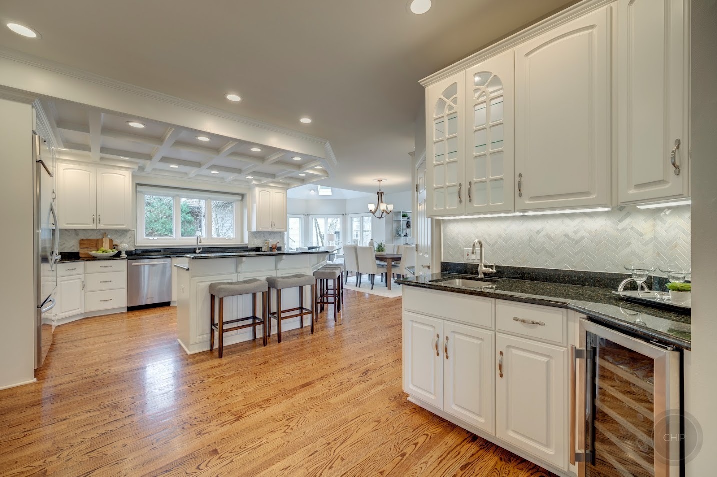 208 Crooked Tree Court Naperville, IL 60565 - Photo 11 of 97 a kitchen with stainless steel appliances granite countertop a stove top oven a sink a dining table and chairs with wooden floor