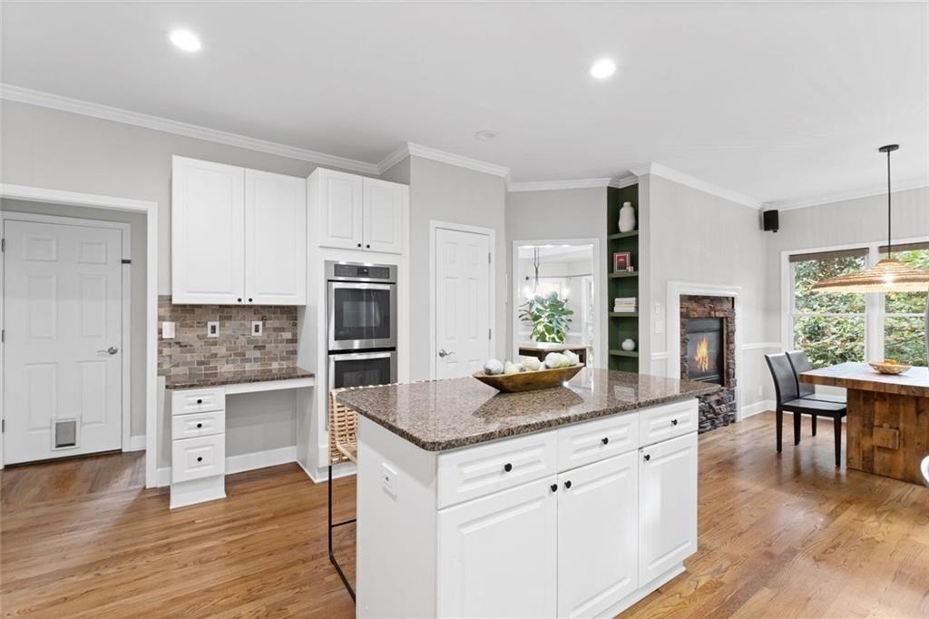 475 Laurian View Court Roswell, GA 30075 - Photo 19 of 66 a kitchen with stainless steel appliances granite countertop a stove and a wooden floors
