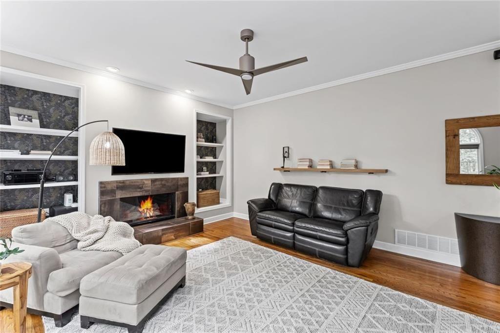 475 Laurian View Court Roswell, GA 30075 - Photo 22 of 66 a living room with furniture a flat screen tv and a fireplace