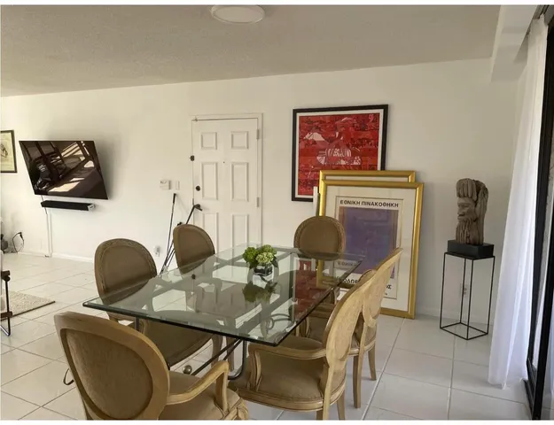 a work room with furniture and a flat screen tv