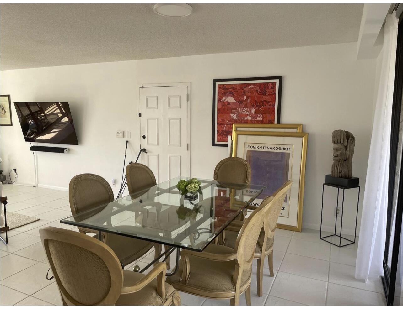 7170 Promenade Drive, Unit 301 Boca Raton, FL 33433 - Photo 3 of 7 a work room with furniture and a flat screen tv