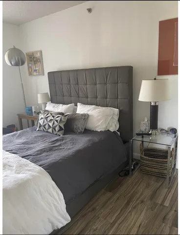 a bedroom with a bed and a lamp