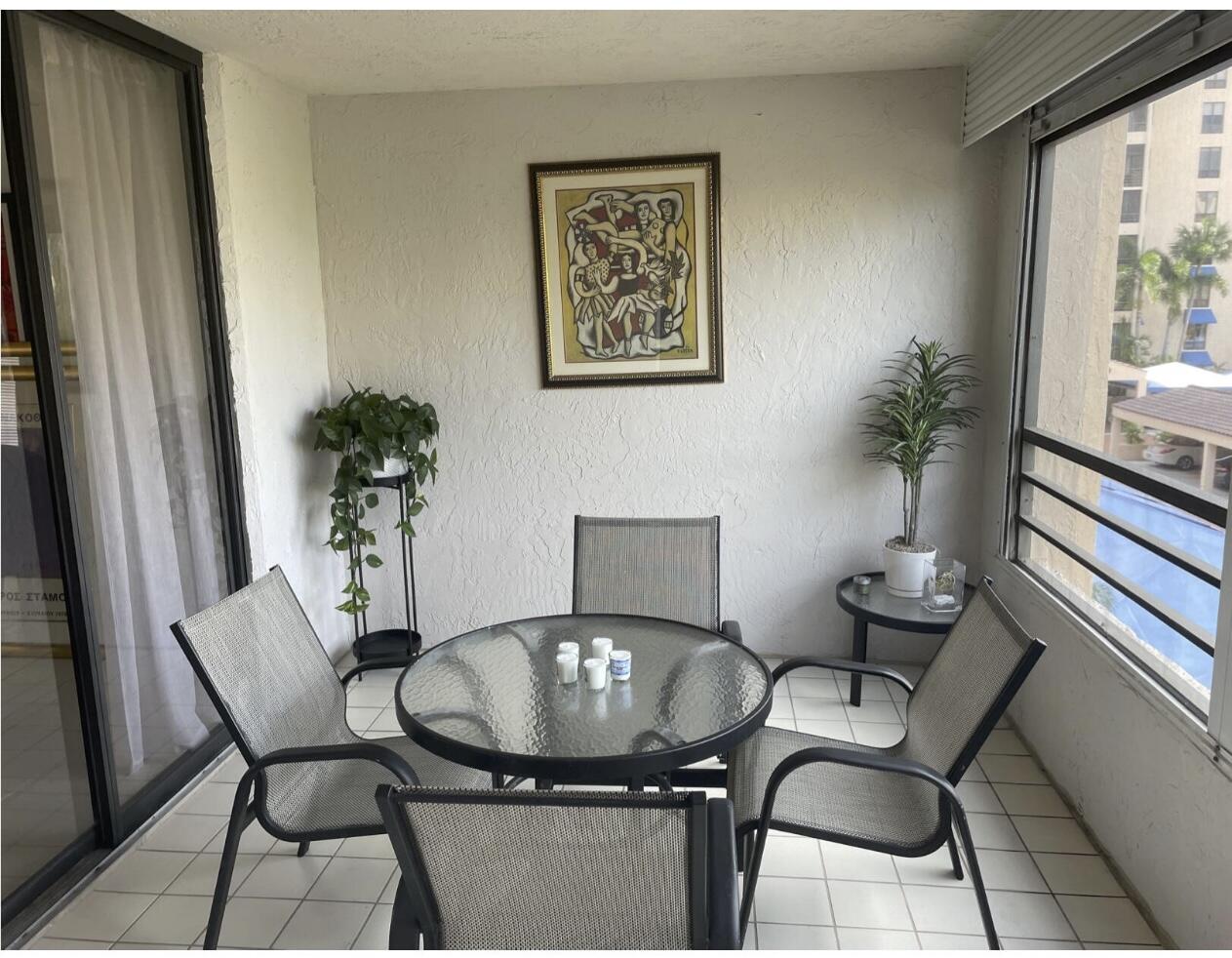 7170 Promenade Drive, Unit 301 Boca Raton, FL 33433 - Photo 6 of 7 a view of a dining room with furniture window and wooden floor
