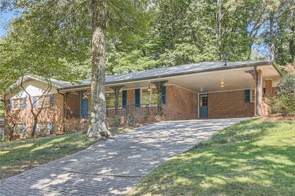 3132 Randolph Road Northeast Atlanta, GA 30345 - Photo 1 of 1 a backyard of a house with table and chairs under an umbrella