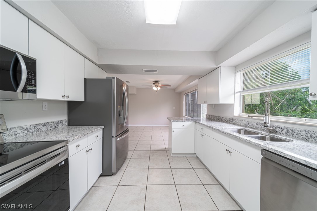 12451 Shawnee Road Fort Myers, FL 33913 - Photo 11 of 39 a kitchen with a sink stove and refrigerator