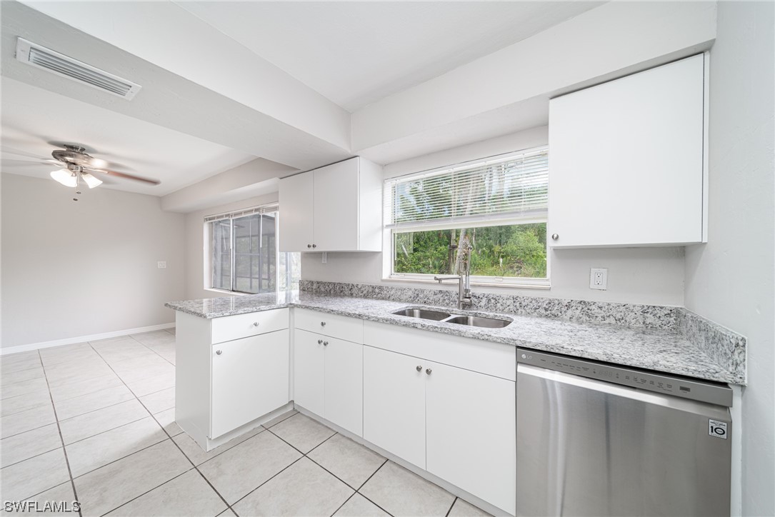 12451 Shawnee Road Fort Myers, FL 33913 - Photo 13 of 39 a kitchen with a sink and cabinets