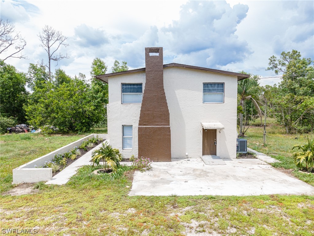 12451 Shawnee Road Fort Myers, FL 33913 - Photo 2 of 39 a front view of a house with a yard