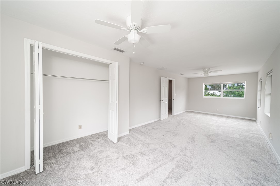 12451 Shawnee Road Fort Myers, FL 33913 - Photo 25 of 39 an empty room with a ceiling fan and a window